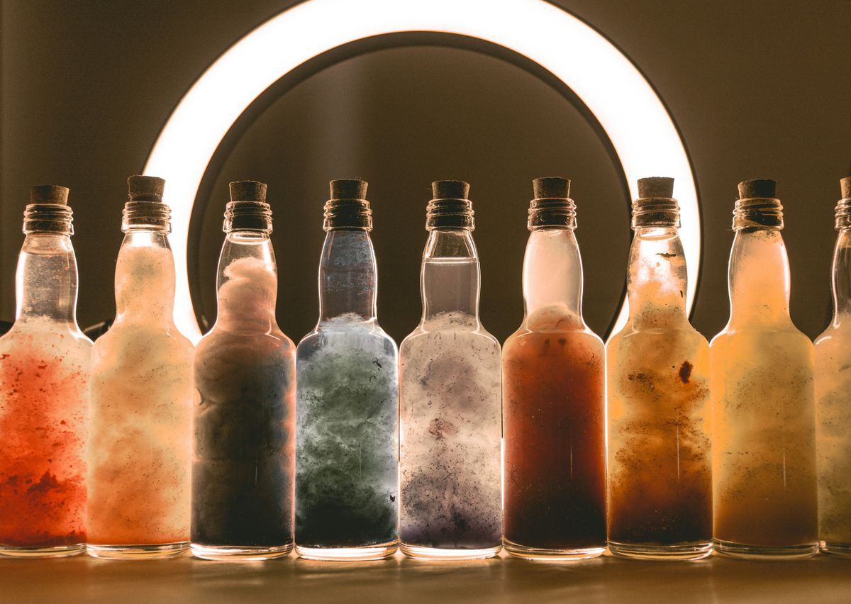 High angle shot of various cosmetic bottles and jars arranged artistically on a textured background