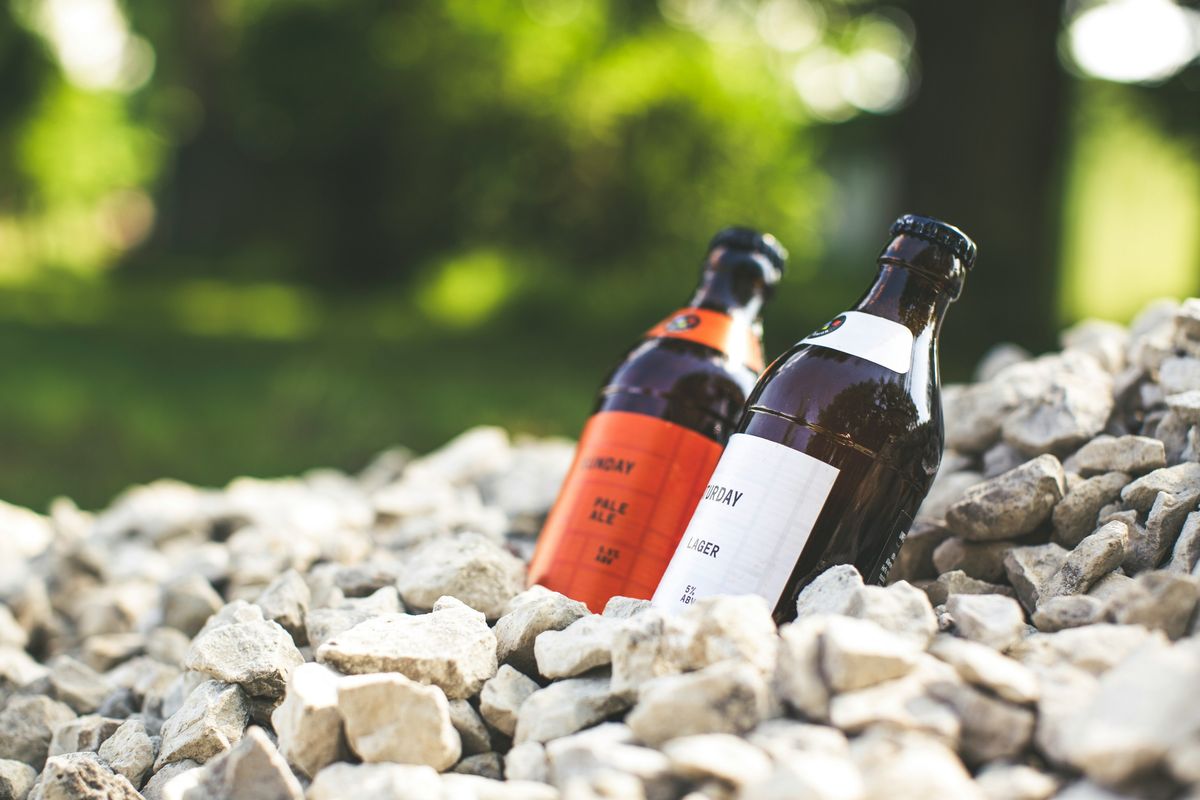 Close up of essential oil bottles and smooth stones on a wooden background