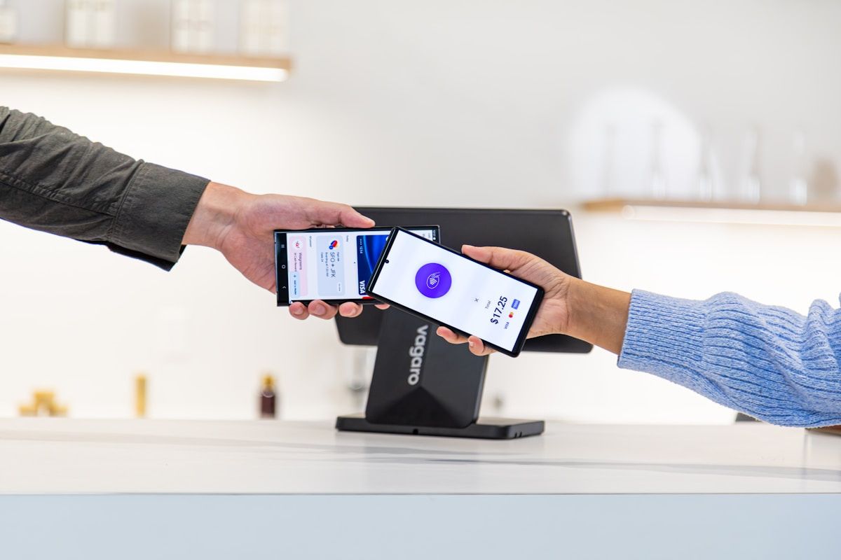 Contactless payment being made with mobile phones.