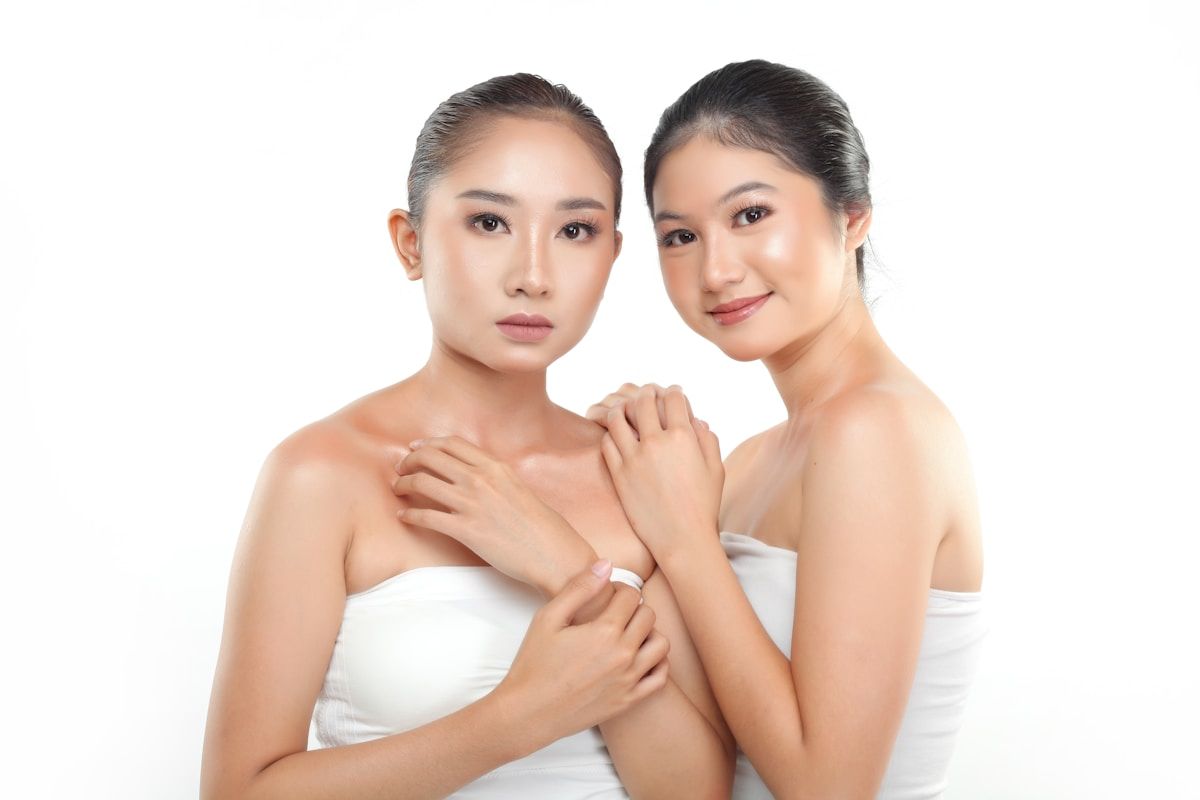 two beautiful young women standing next to each other