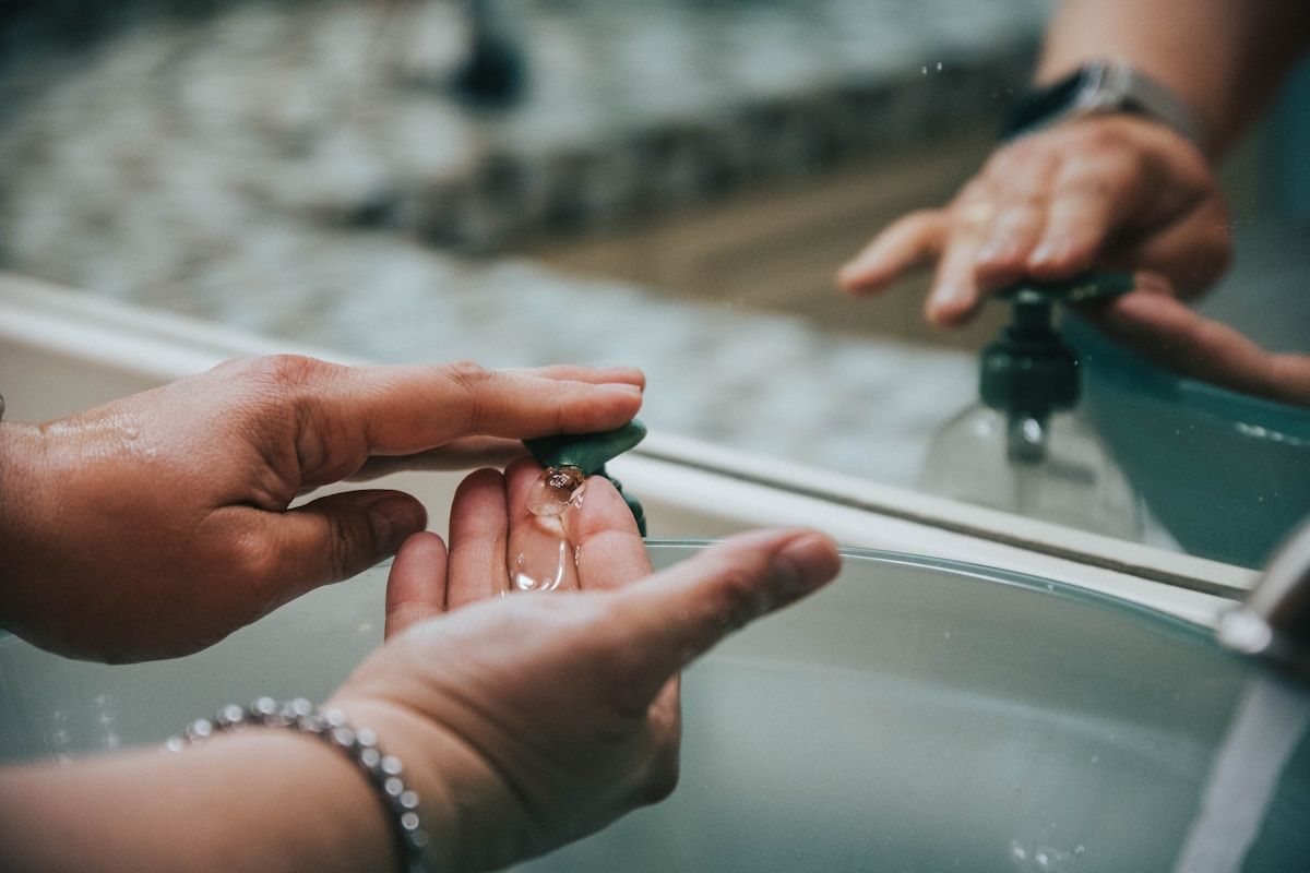 Mains lavant soigneusement sous l'eau courante.