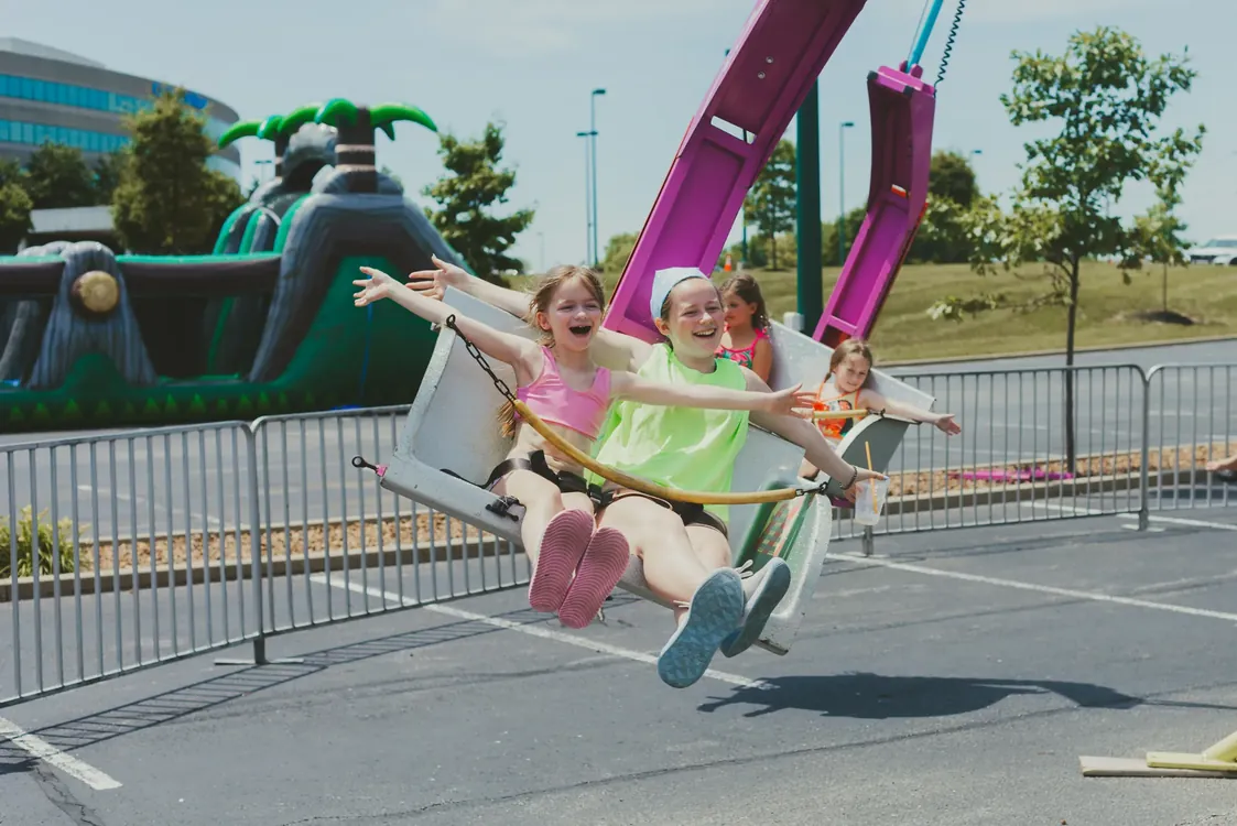 Kids laughing on a swing ride