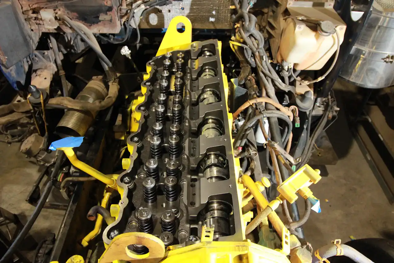Engine rebuild showing exposed valve springs and camshaft components on a heavy-duty diesel engine