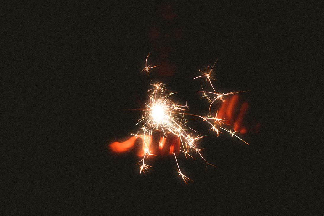 person holding sparkle