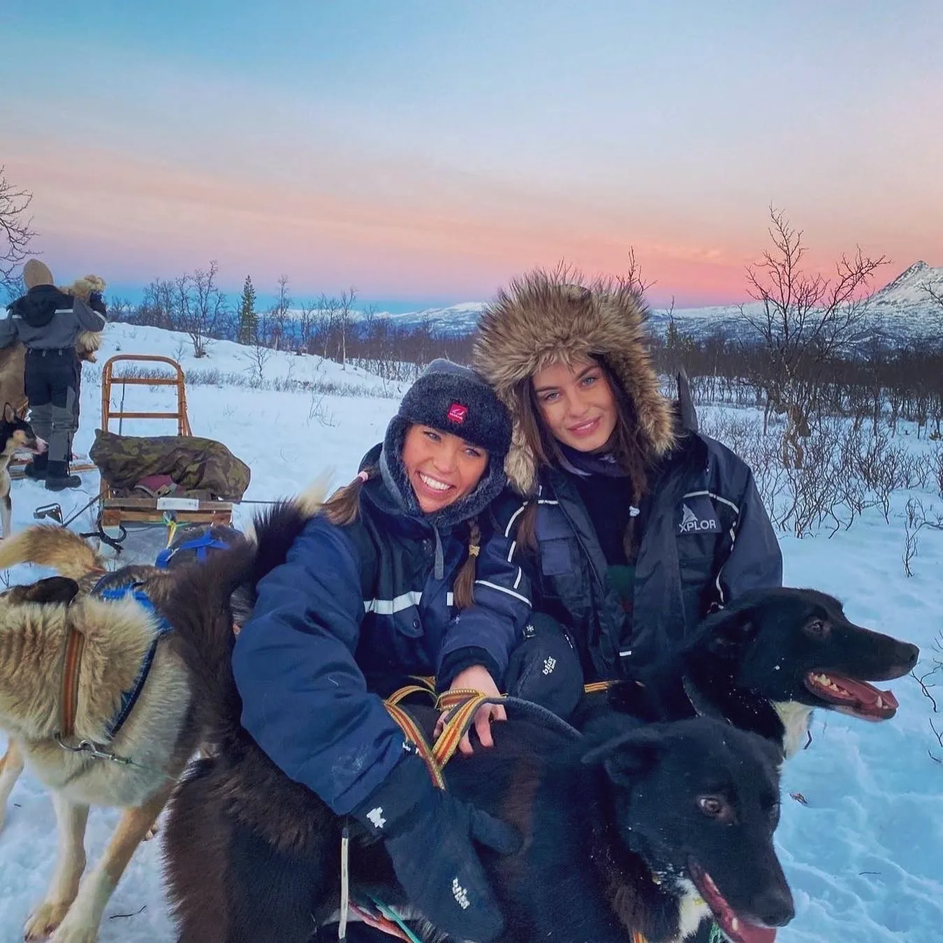A couple poses together in a snowy setting.