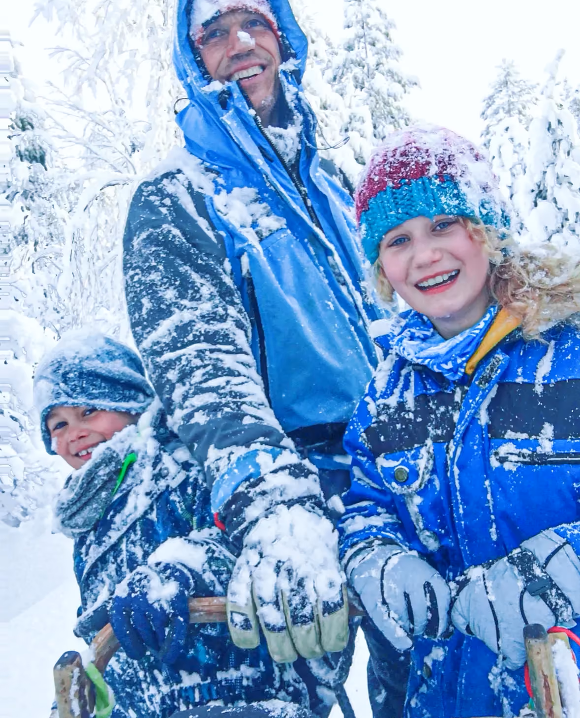 A couple embraces in a snowy landscape.