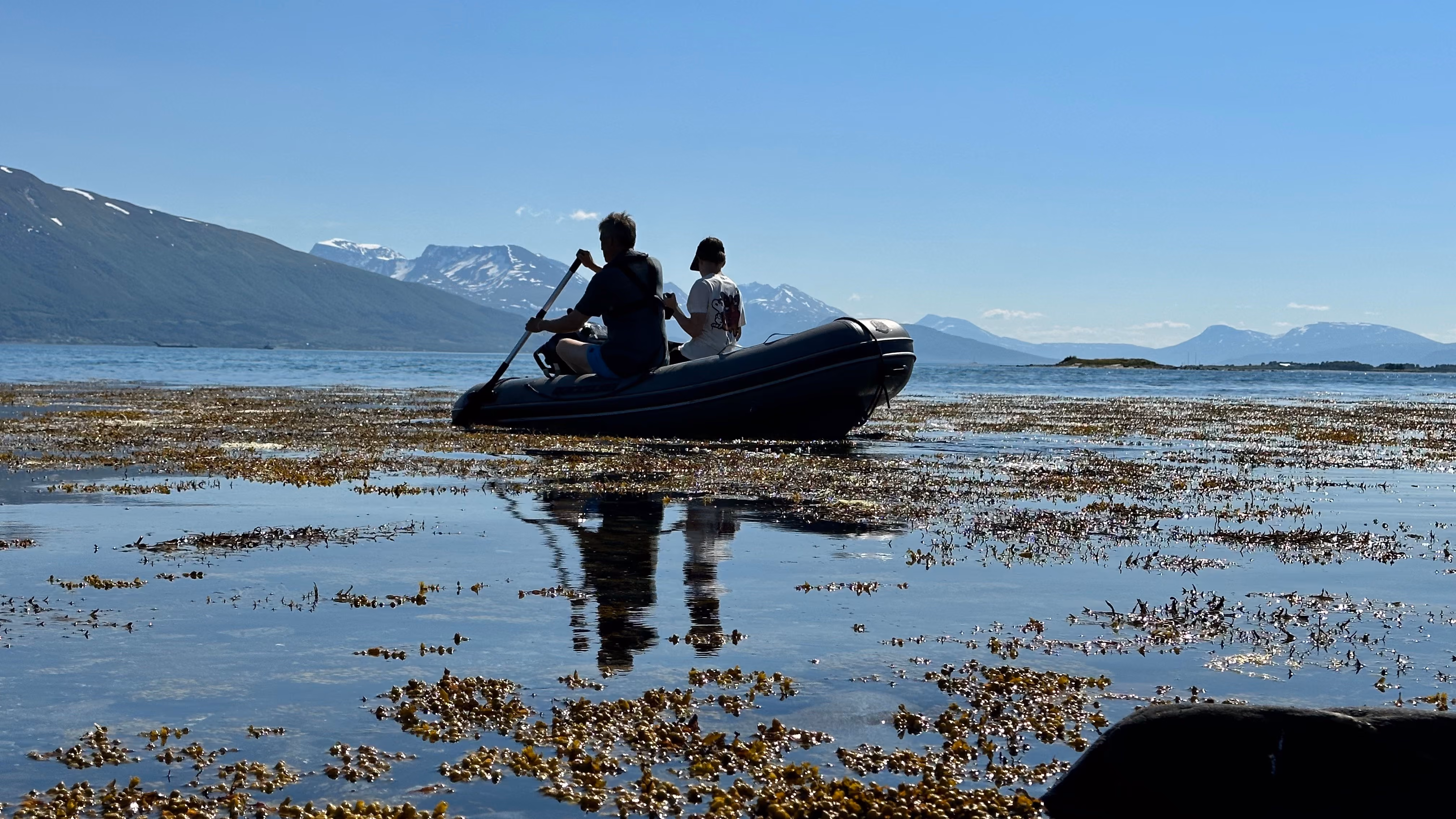 two people in a little boat on the ocean
