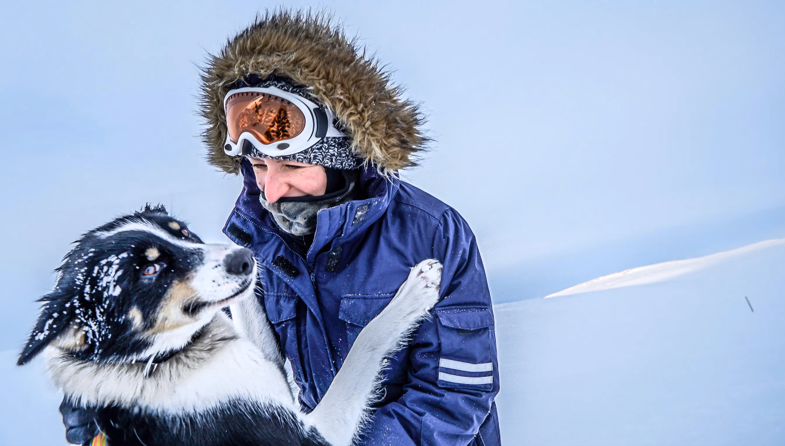 Woman smiling at a husky dog