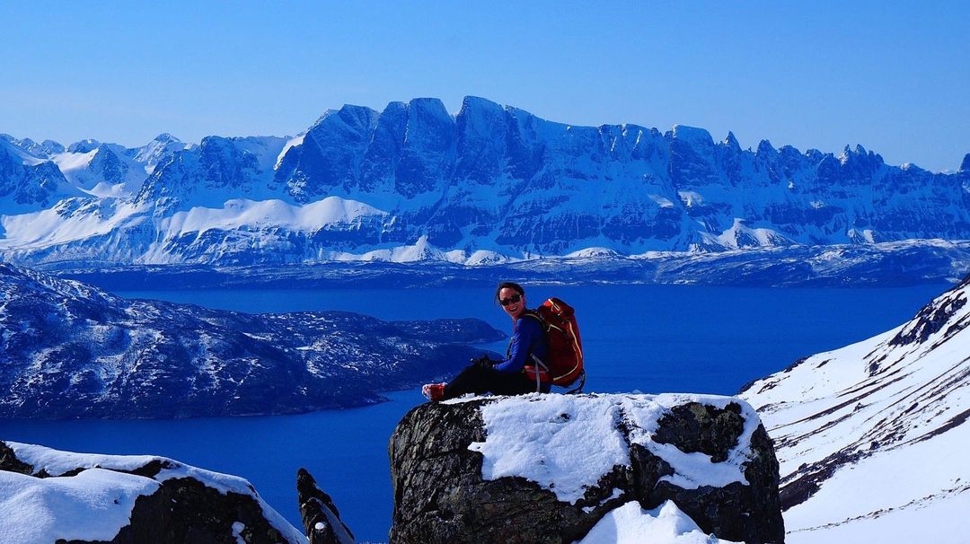 Jagged, snow-capped mountain peaks under a crisp blue sky.