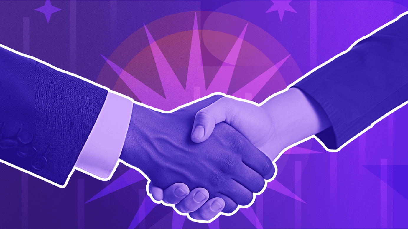 Two businessmen are shaking hands in agreement and understanding. 