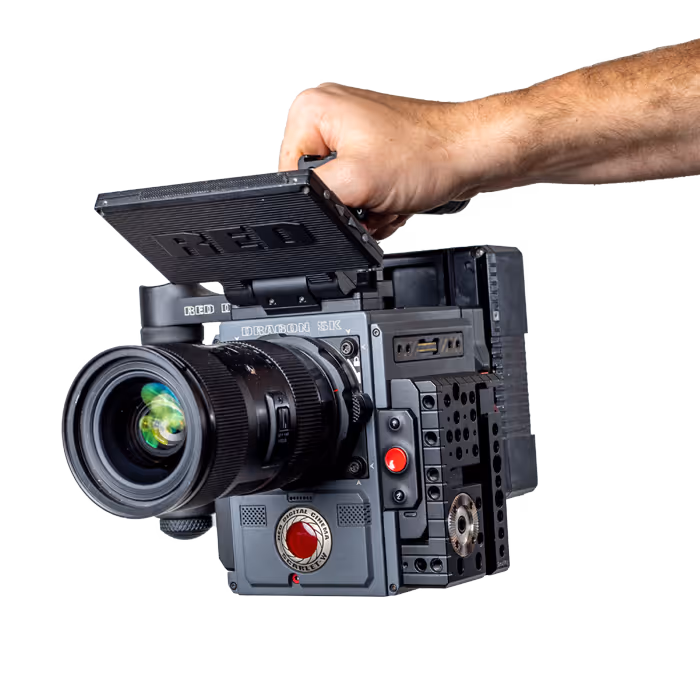 A video camera held by a hand