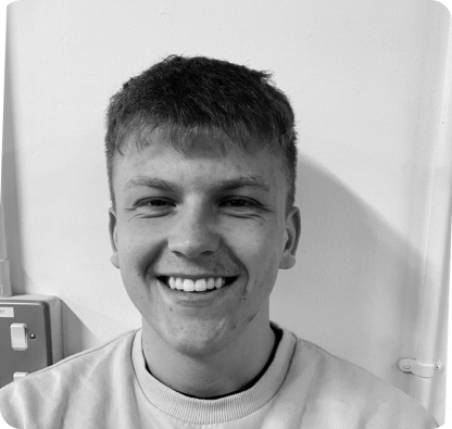 a black and white photo of Luke smiling