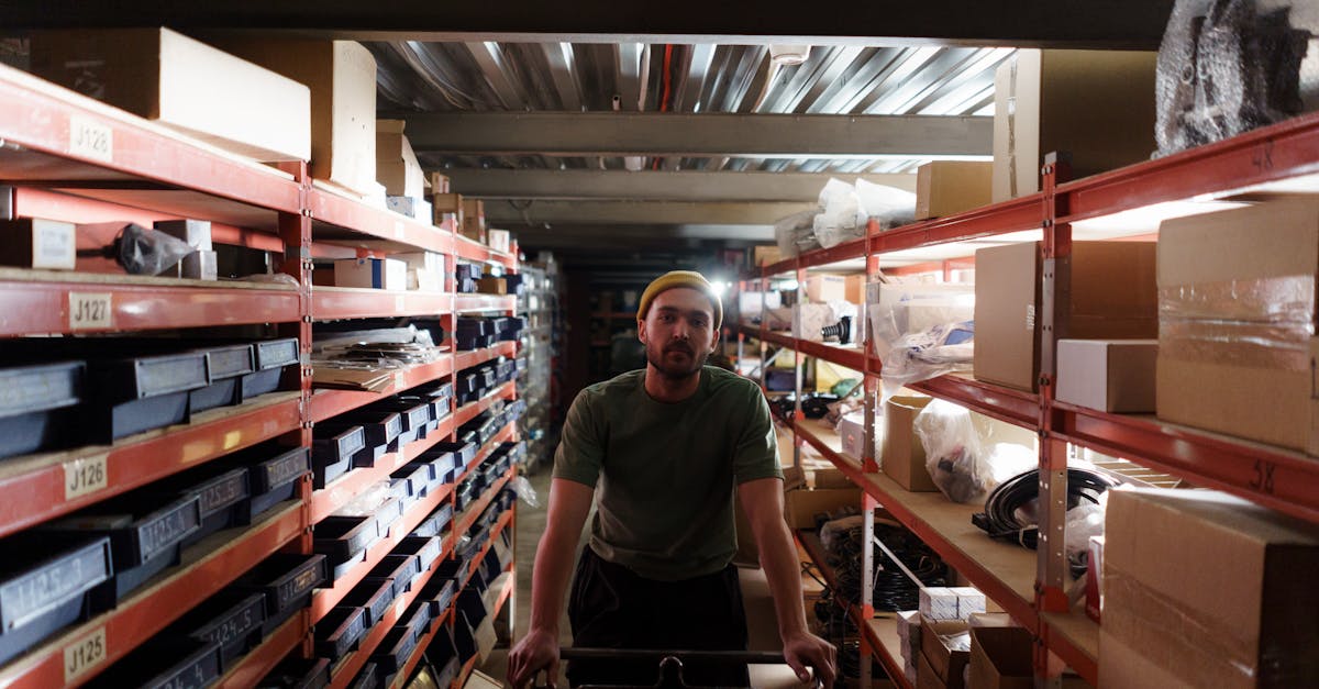 Worker moves a cart through a busy warehouse aisle where 3PL fulfillment chargebacks originate at the pick face