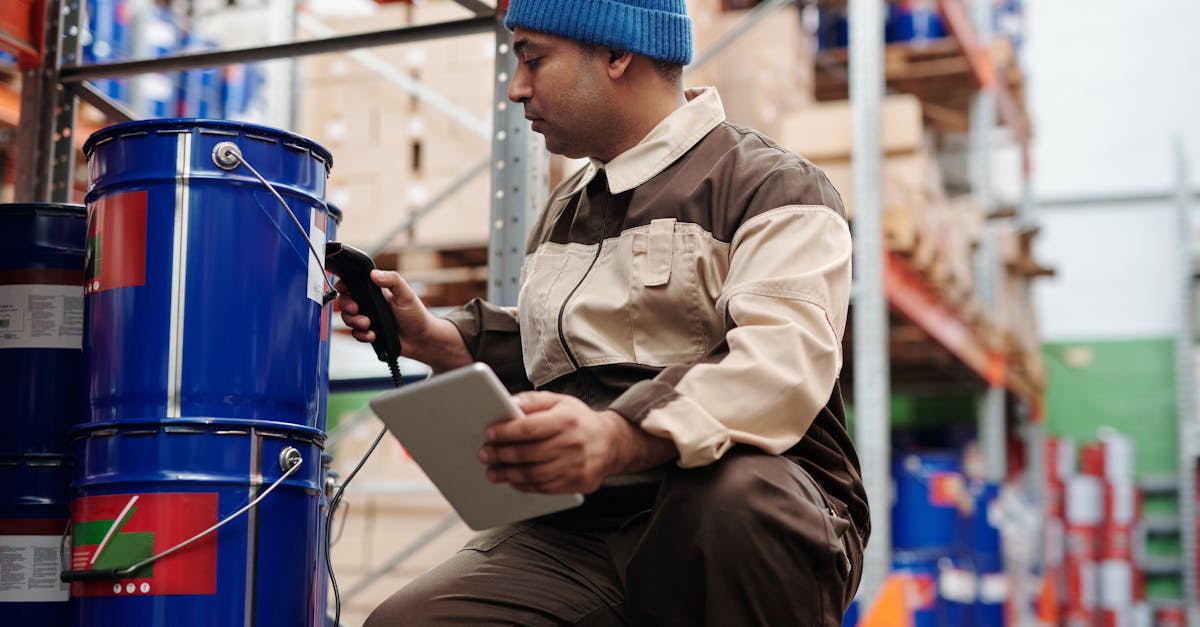 Warehouse employee scanning items with tablet and scanner for cycle count time reduction using weight-based verification