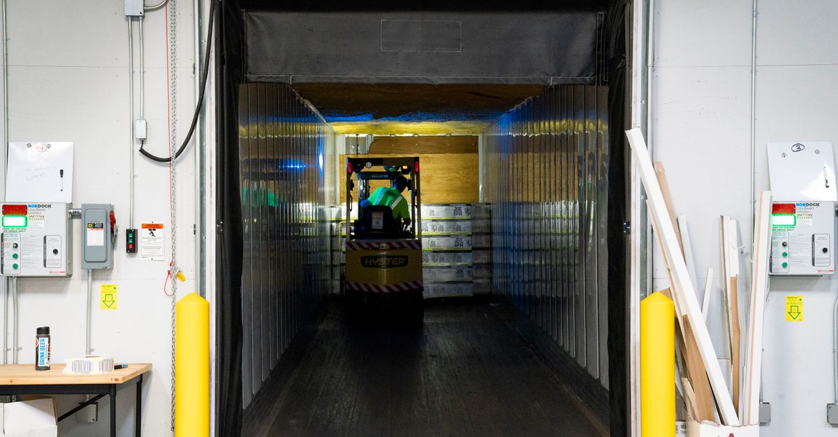 Forklift unloading goods at an industrial loading dock where receiving accuracy is set