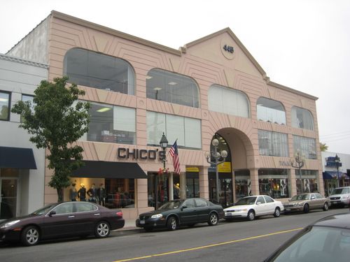 A facade of a three-story building with big windows
