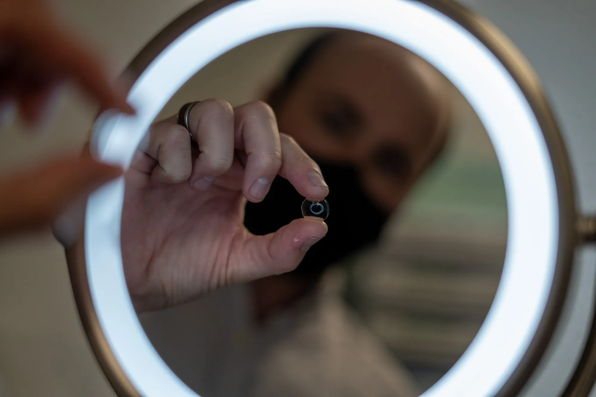 Contact lenses being inspected in a mirror
