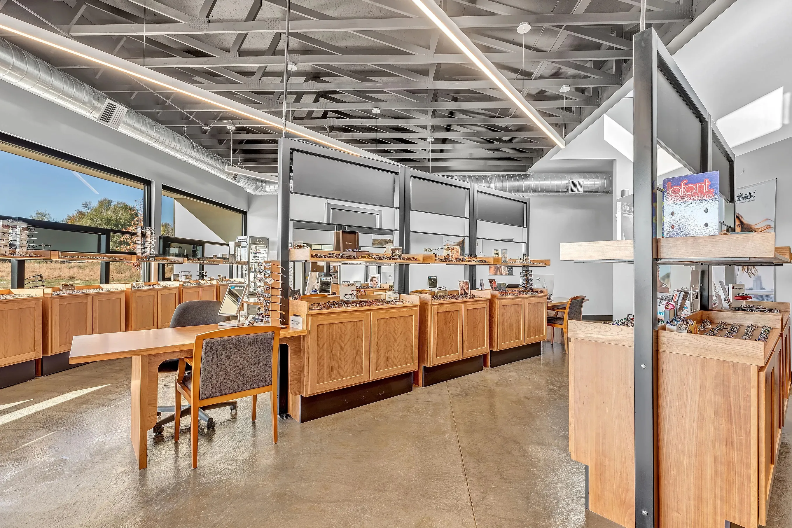 Inside of Carbon Valley Eye Care with wooden cabinets and display cases