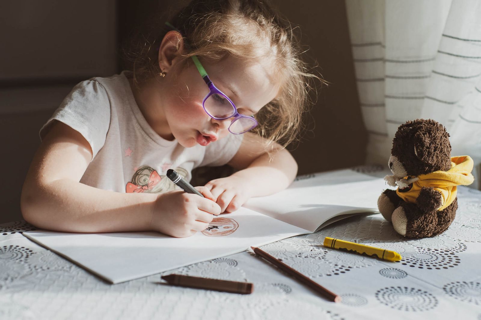 child drawing with glasses on