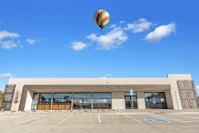 Hot air balloon flying over a building