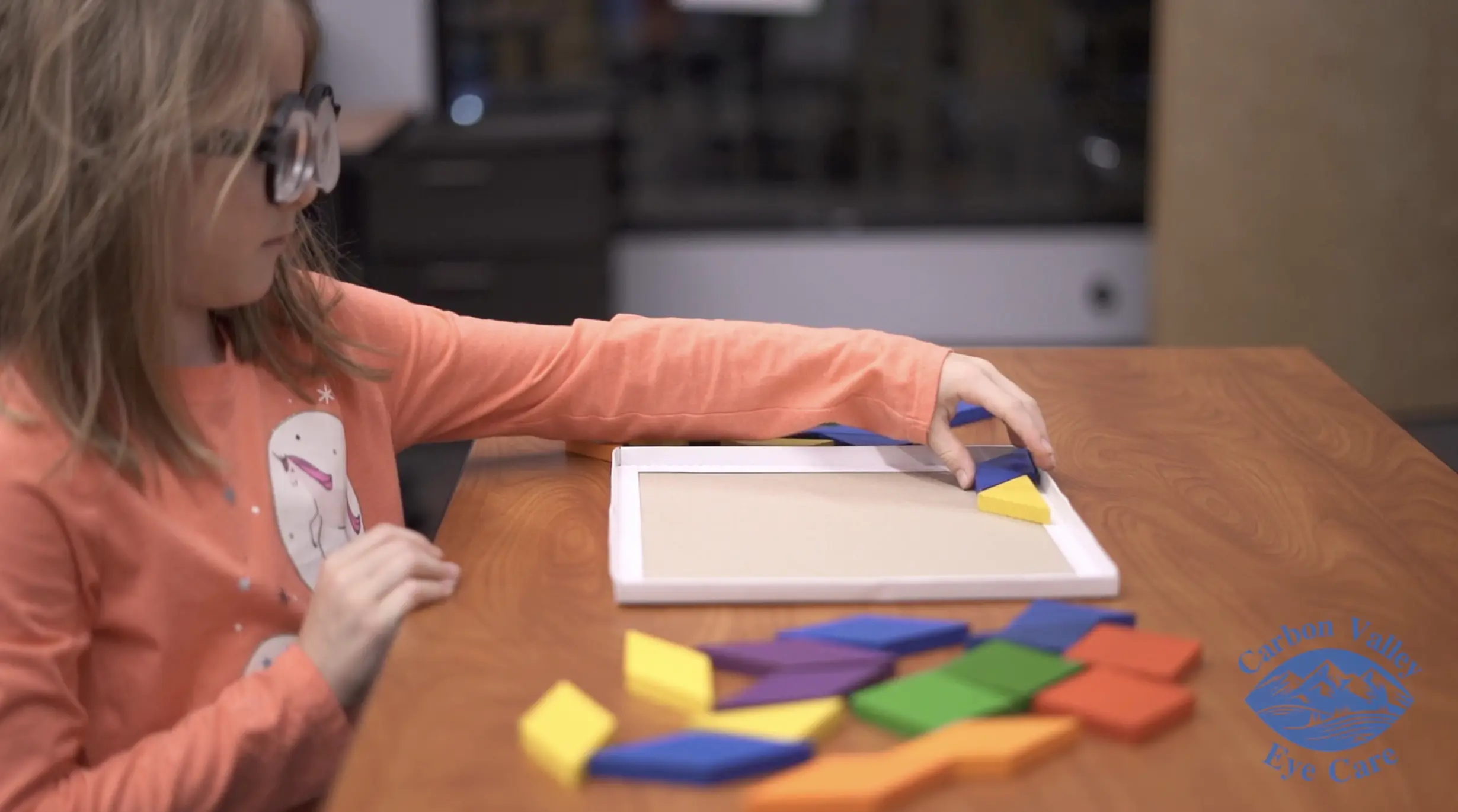 Child with glasses playing with a board game