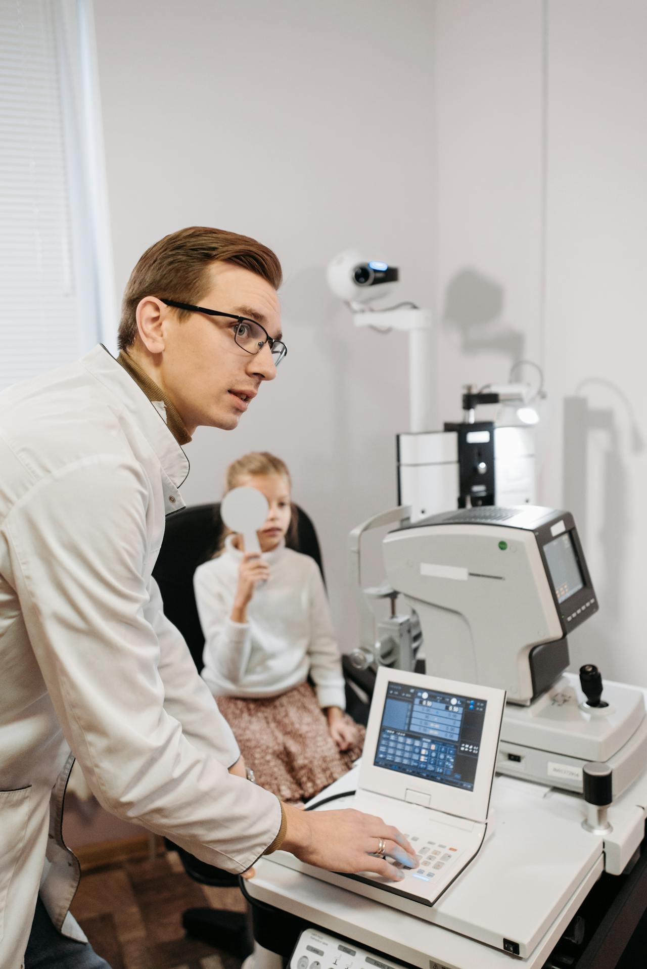 pediatric eye doctor giving an eye exam