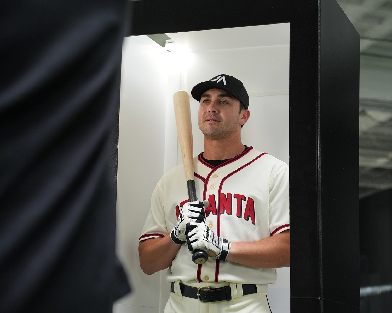 behind the scenes photo of man in baseball uniform being photographed