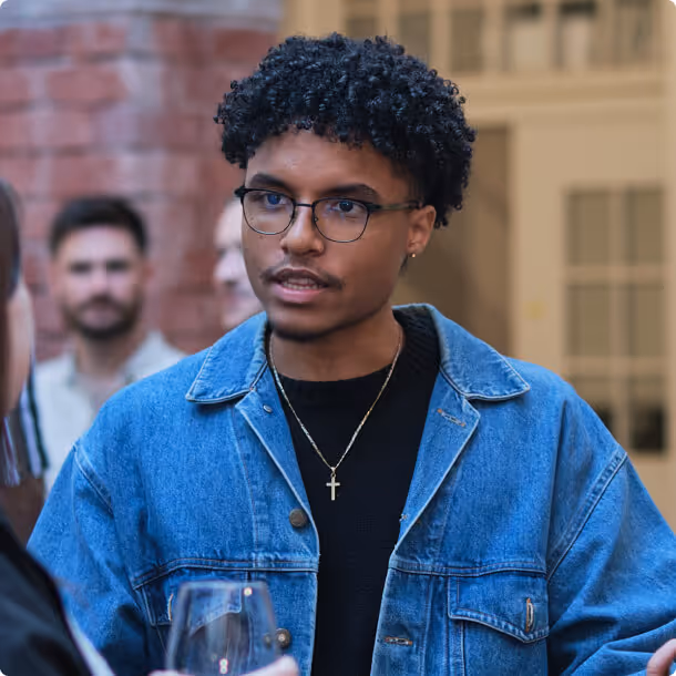 A man with glasses talking to a woman.