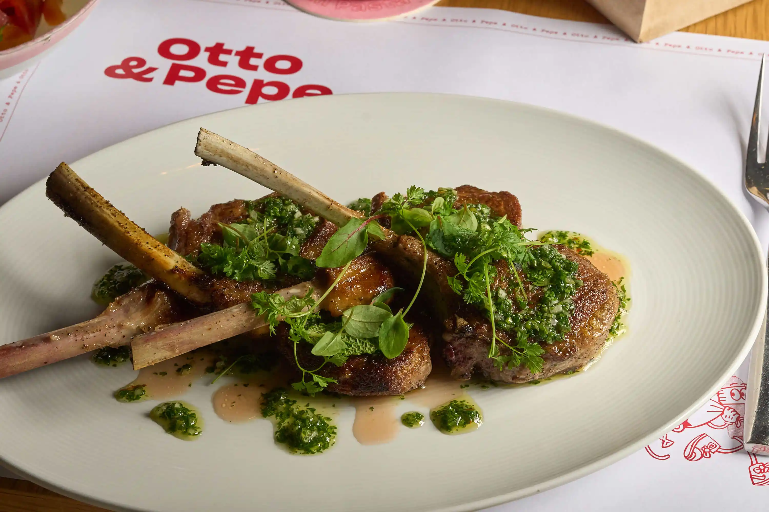 Grilled lamb chops with fresh herbs served at Otto & Pepe, Italian restaurant in Miami