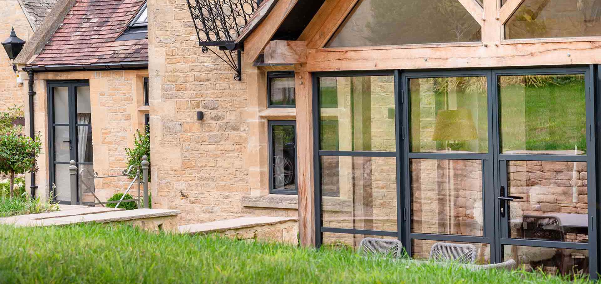 Garden shot of Grey Crittall look door with renovation