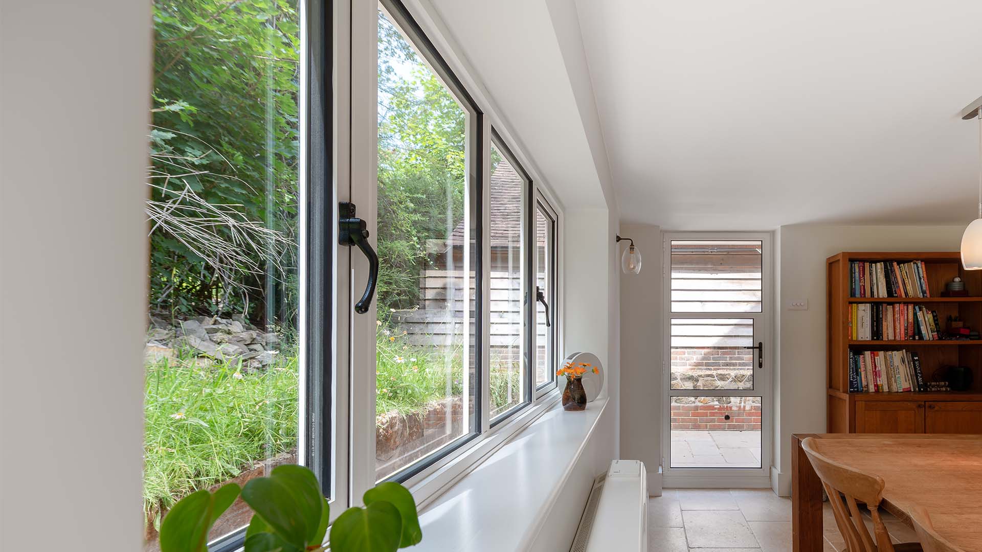 Internal kitchen view of hinged heritage door and windows in white
