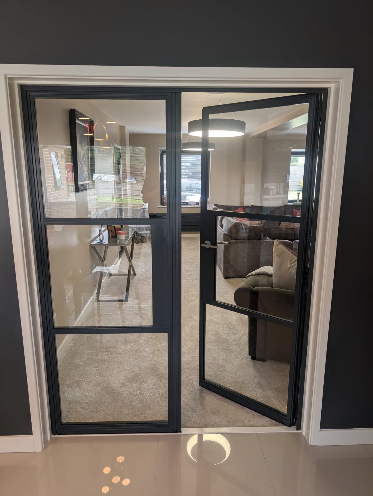 industrial french door opeing into living room