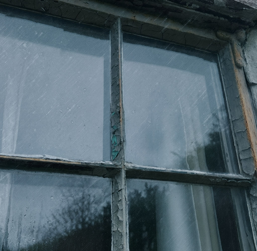 Old rusted steel window being battered by british storm