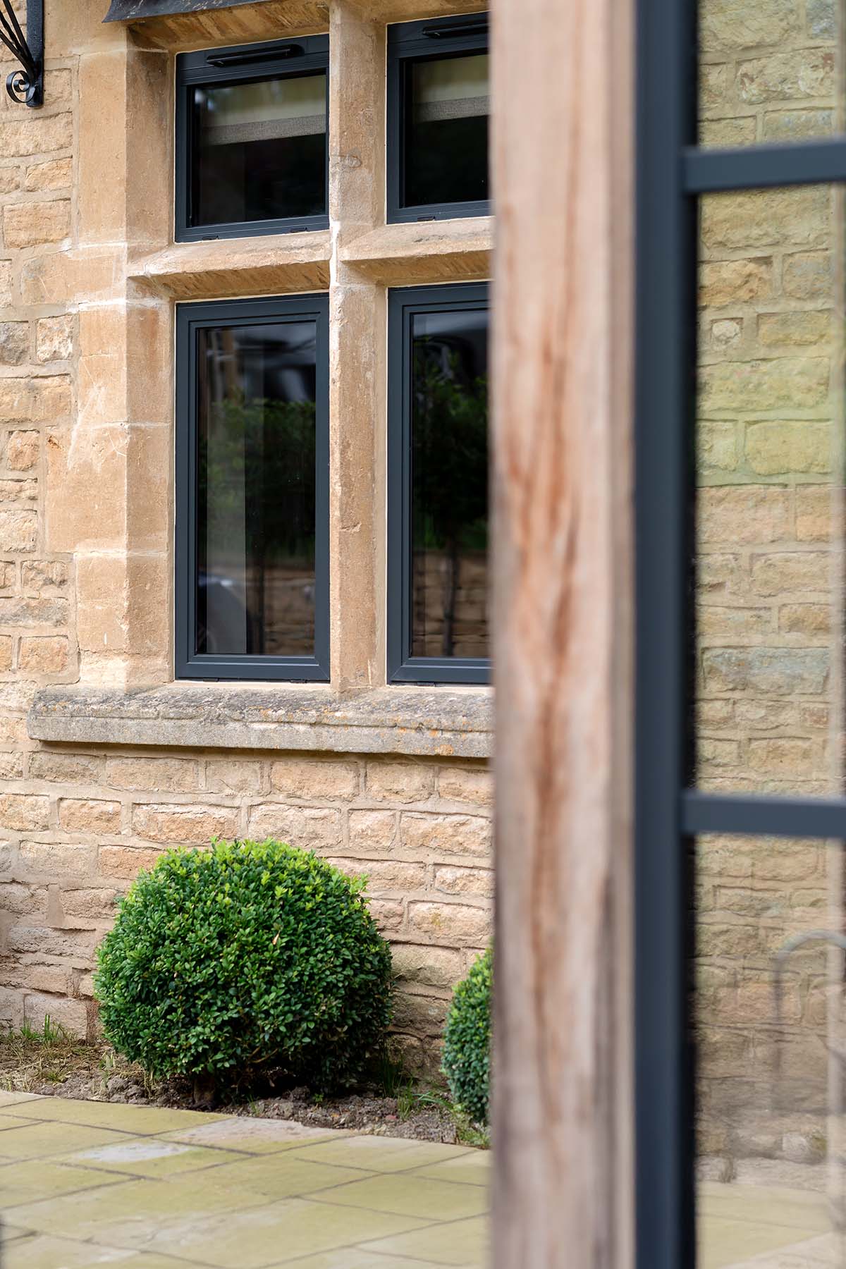 Grey aluminium conservation windows set within a period stone property