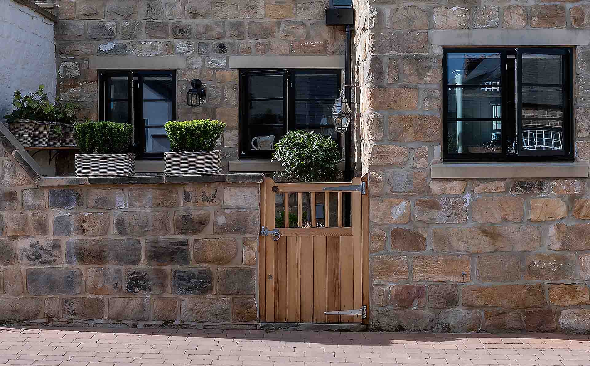 Stone Yorkshire property featuring black heritage aluminium windows and doors