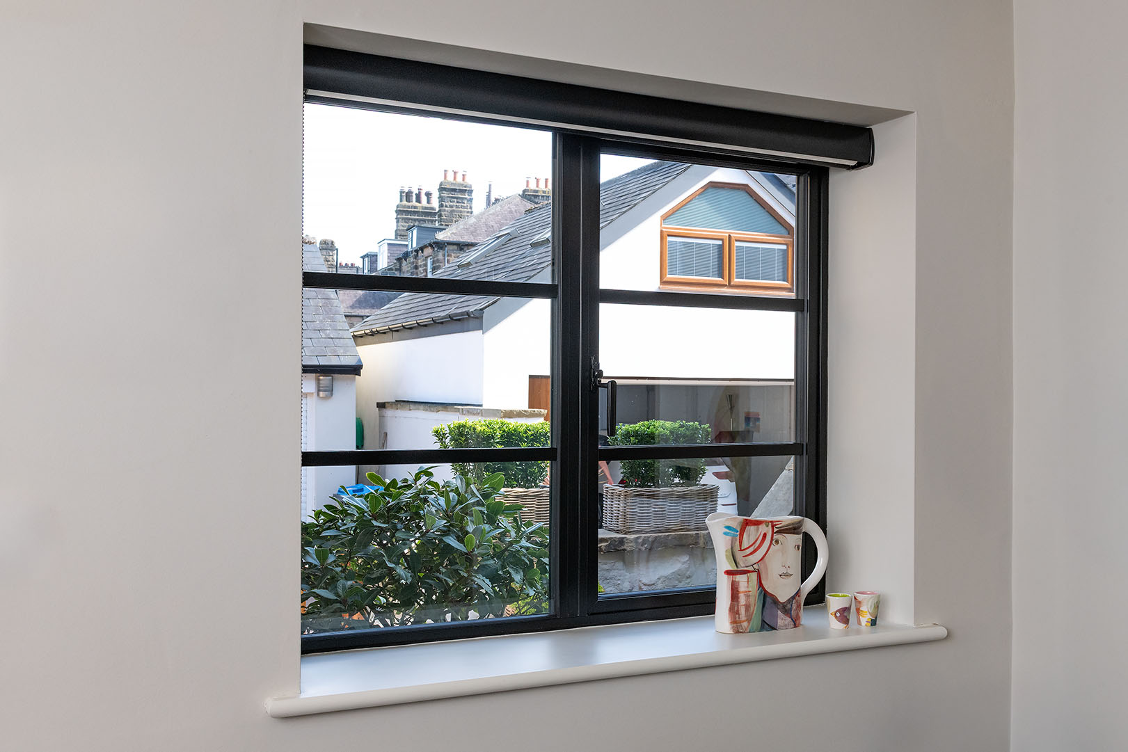 Interior view of black heritage aluminium window with slim frames and glazing bars in a Harrogate home