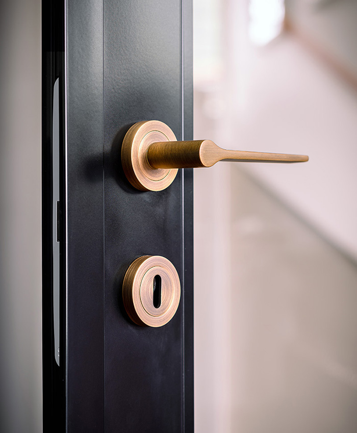 Antique brass handle and lock on internal steel look door