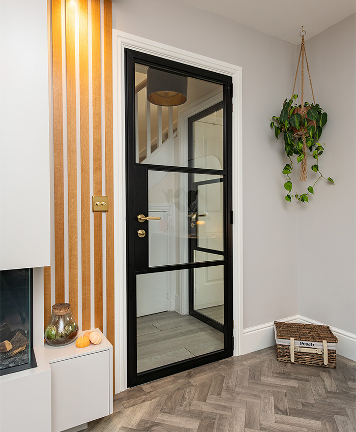 Black art deco glass door with gold handles