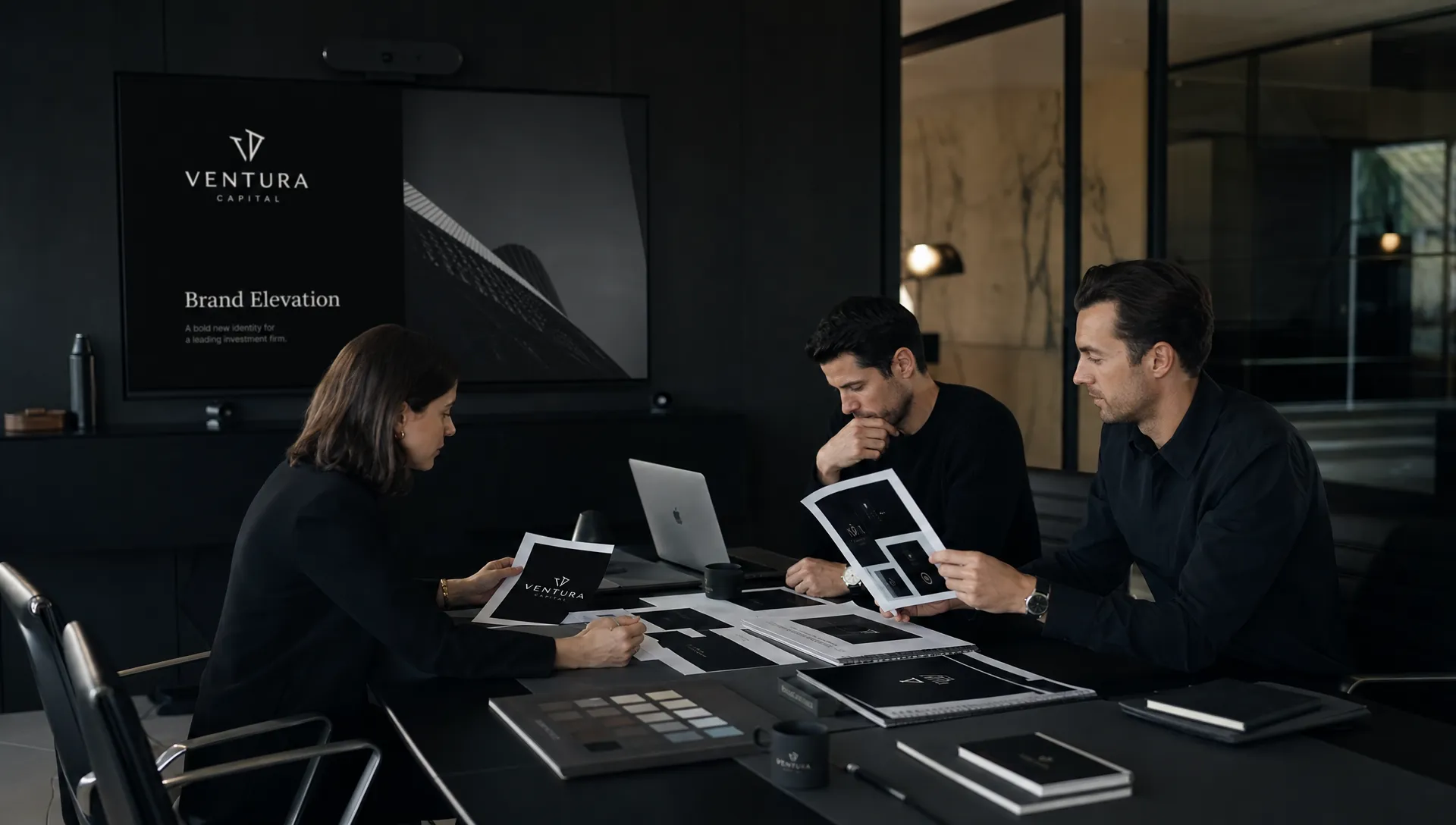 A marketing team reviews portfolio samples, brand strategy notes, and launch materials while evaluating a branding vendor.