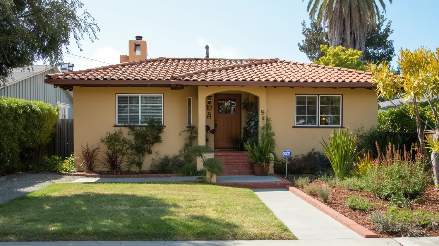 an exterior of a modest size home in the silicon valley california. house is painted brown