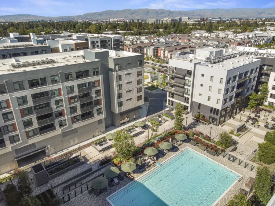 an aerial of a condo complex with a large pool in the foreground