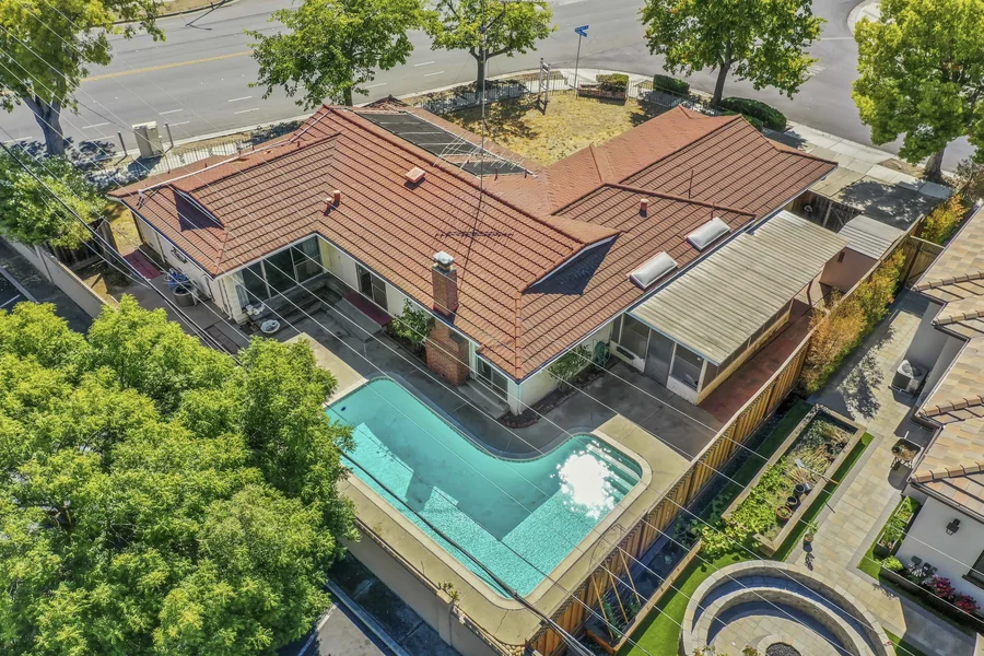 an aerial of a beautiful home with a pool
