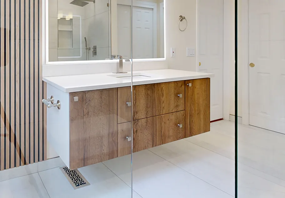 Floating walnut bathroom vanity with white countertop installed by DuetRight in Green Lake, Seattle