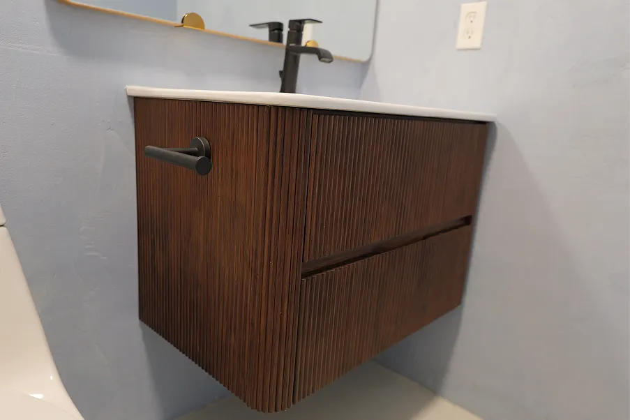 Ribbed walnut floating bathroom vanity with two drawers and matte black hardware installed by DuetRight in Kirkland