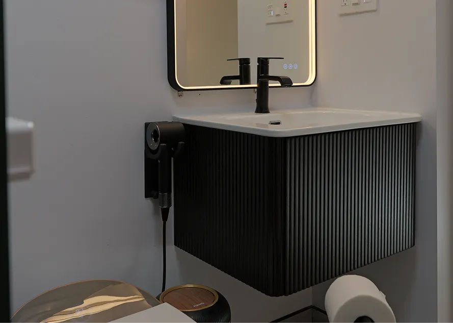 Matte black ribbed floating bathroom vanity with LED mirror installed by DuetRight in Seattle