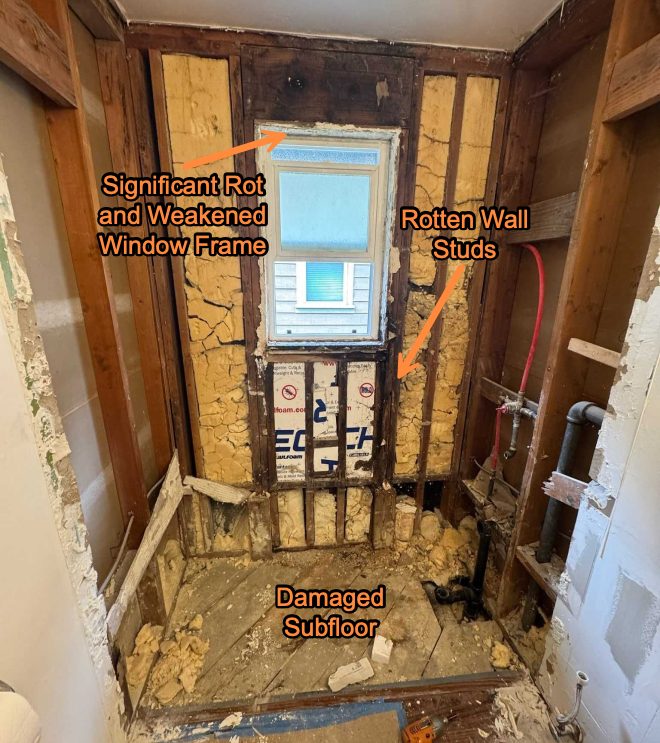 Shower renovation showing significant rot in the window frame, rotten wall studs, and a damaged subfloor, exposing structural issues.
