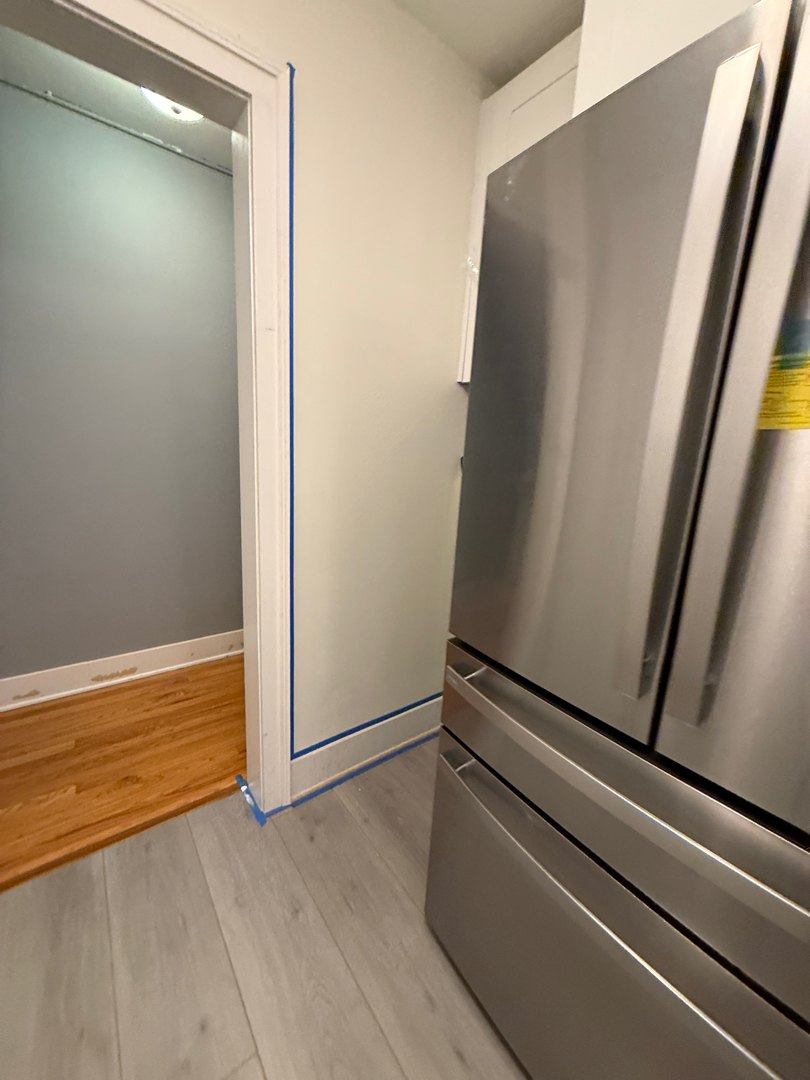 Full-size stainless French-door refrigerator installed in its cabinet opening
