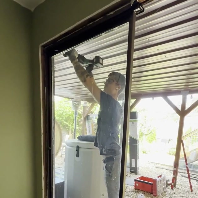 DuetRight technician removing an old sliding patio door in a West Seattle home.