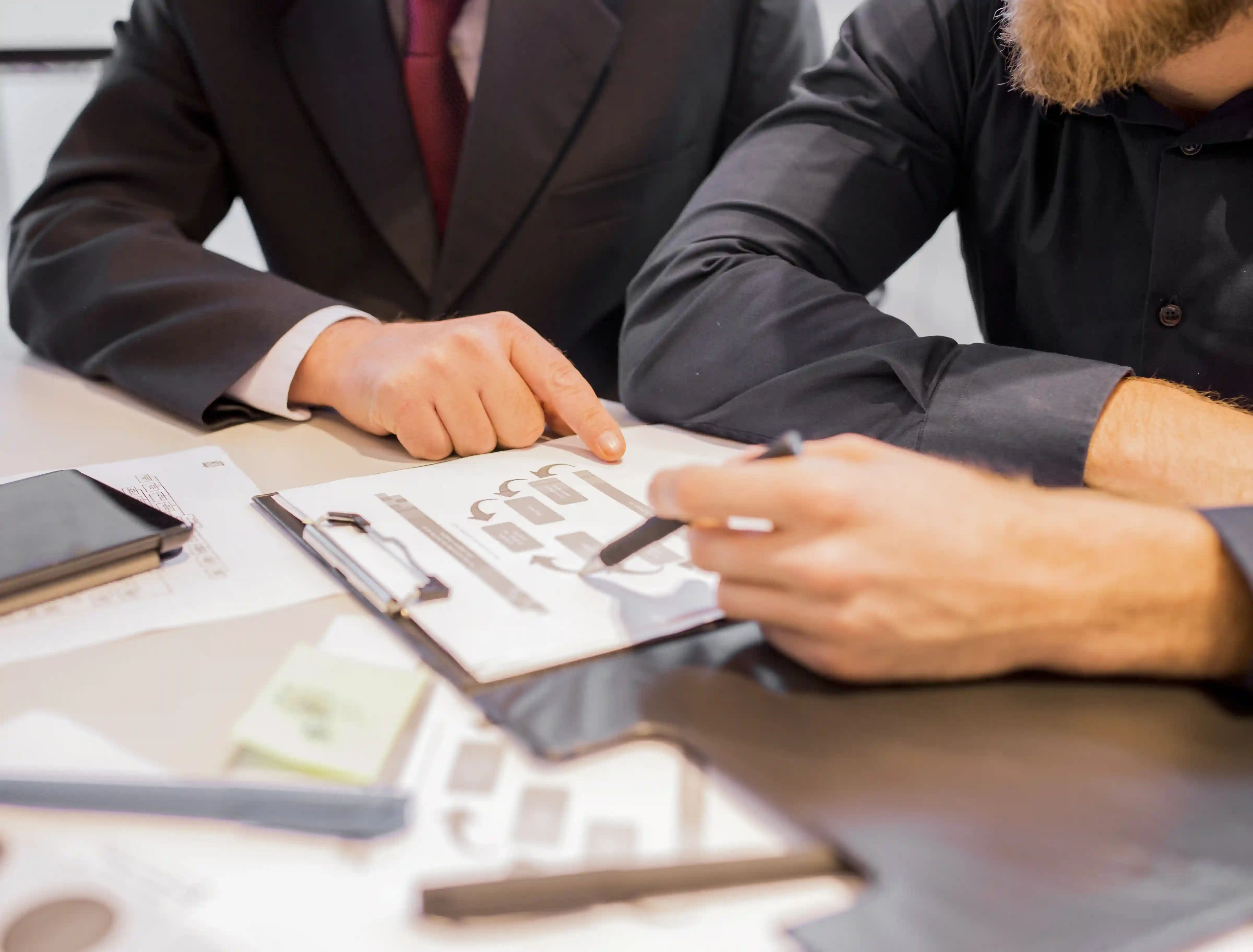 Business owner consulting a lawyer about legal considerations when raising capital