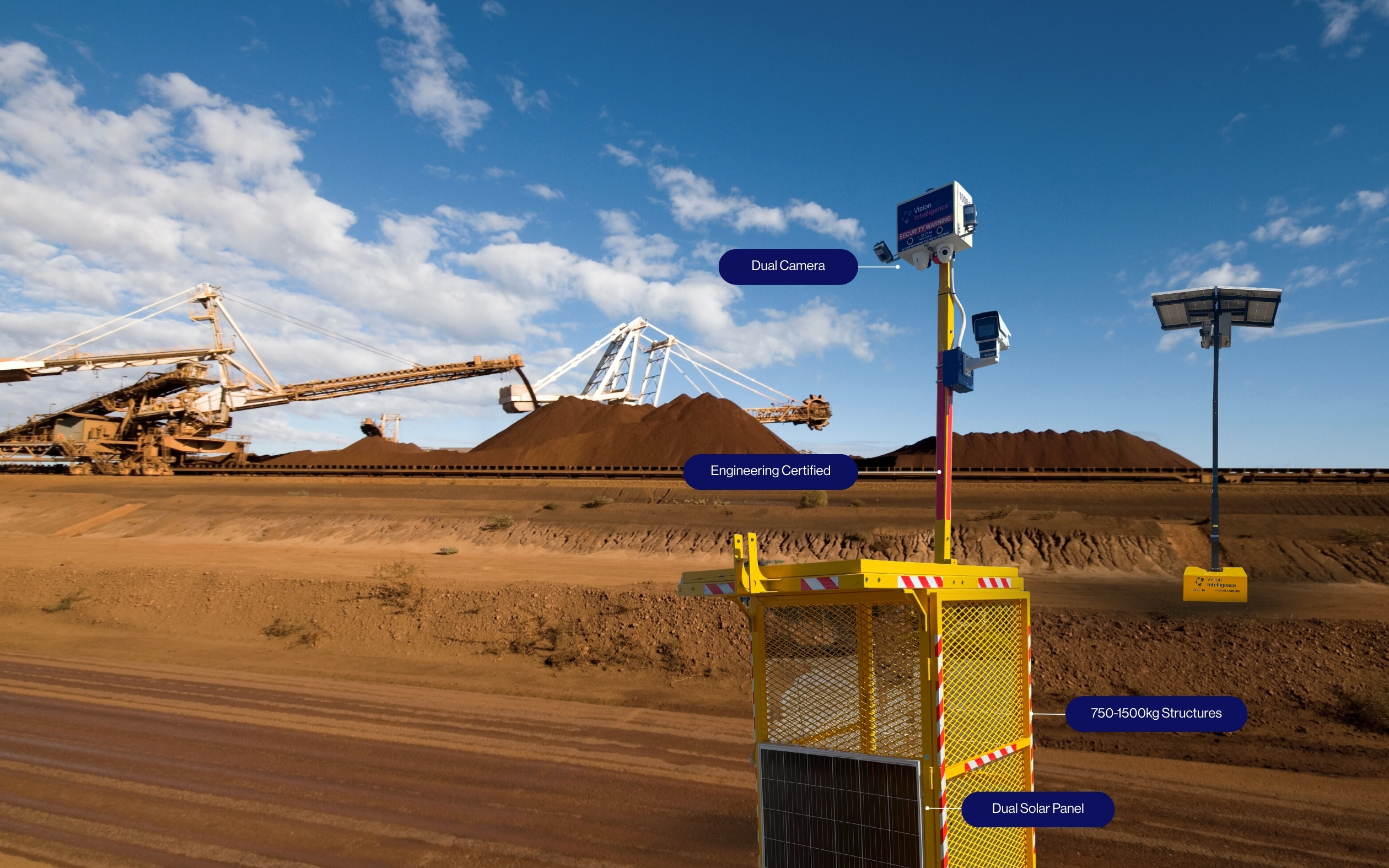 Yellow industrial camera system with dual cameras, solar panels, and engineering certification in a mining site.
